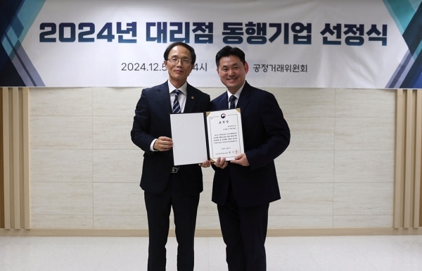 (왼쪽부터) 조홍선 공정거래위원회 부위원장과 조동주 이랜드월드 대표이사가 동행기업 표창장을 들고 사진 촬영하고 있다. /사진=이랜드월드